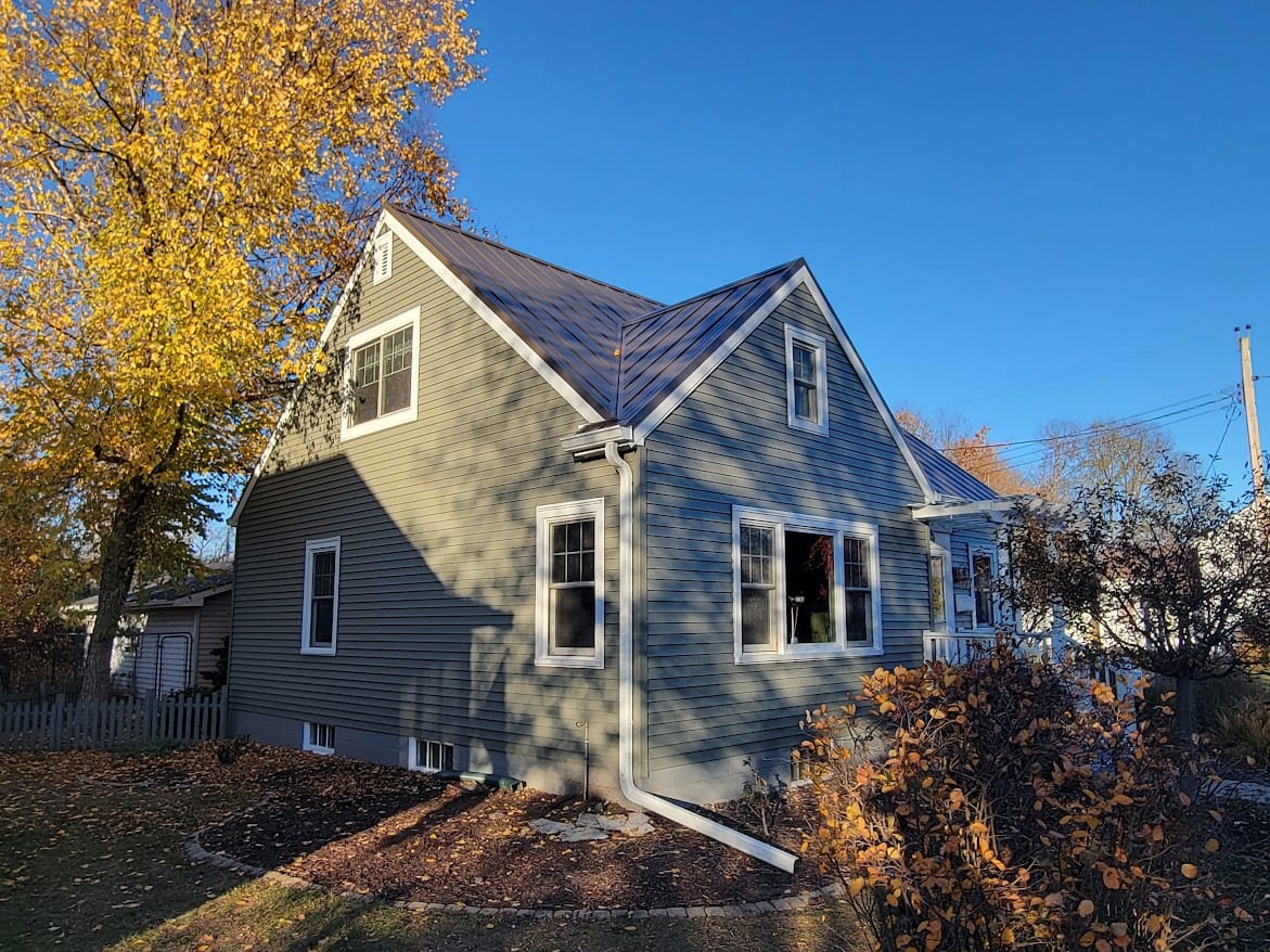 Hidden fastener Steel Roof and Seamless Gutters, Window Wraps and chimney removal - Roofing project in Eau Claire, WI